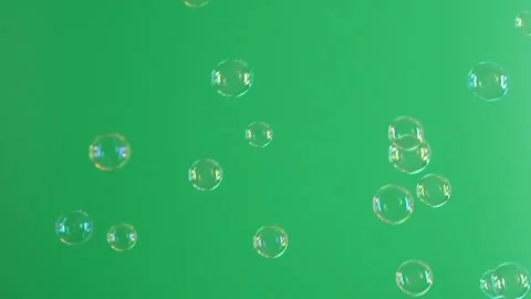 Slow motion of soap air bubbles texture on chroma key green screen background Stock Footage 250378379