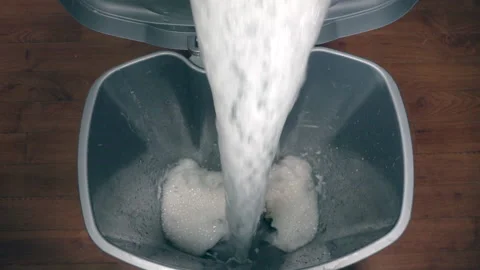 Slow motion - Soapy water being tipped into a dirty plastic trash can. Stock-Footage 195439314