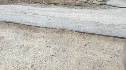 Slow motion soccer ball rolling on concrete ground Stock Footage 65633751