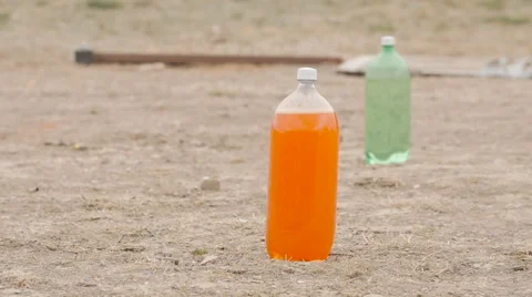 Slow Motion Soda Bottle Explodes After Shot Stock Footage 60704437