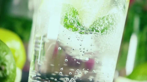 Slow motion soda bubbles in a glass of mint and citrus Stock Footage 92319961