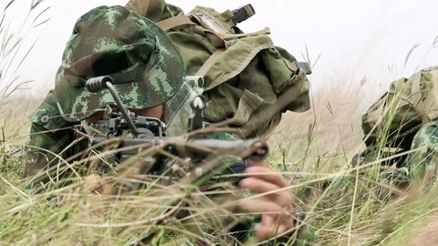Slow motion of soldier loading his assault rifle on grass. Stock Footage 92305454