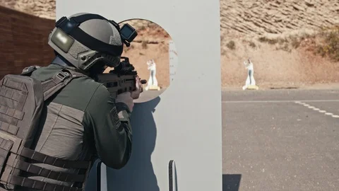 Slow motion of soldier shooting automatic rifle in a range Stock Footage 121644360