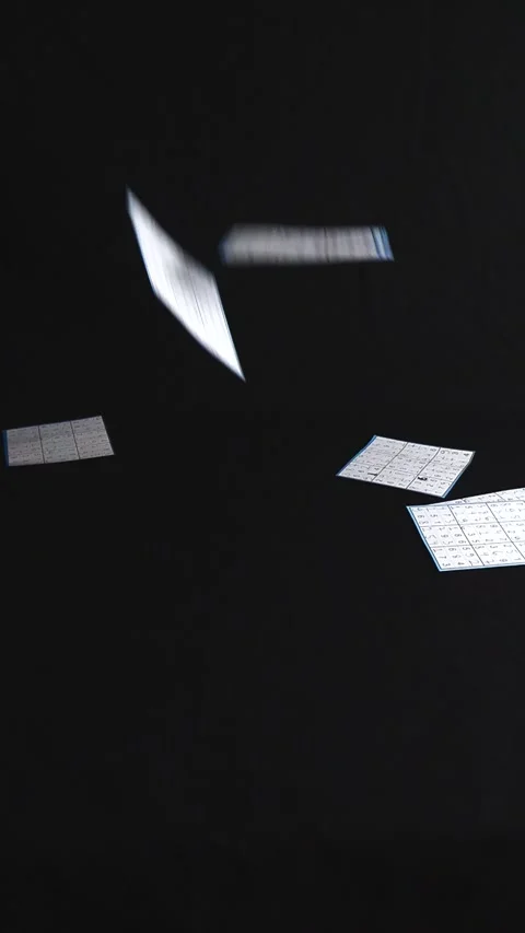 Slow motion solved sudoku puzzles falling on a black background Stock Footage 340555295