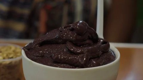 Slow Motion of Some Oats Being Sprinkled Onto a Bowl Full of Chocolate Dessert - Stock Footage 109141378