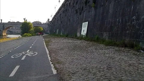 Slow Motion some people jog In Rome near the Tiber river with Sant'Angelo bridge Stock Footage 108503855