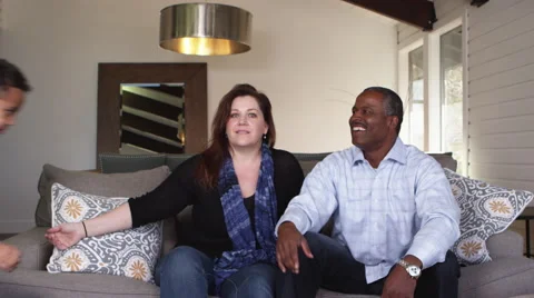 Slow motion son jumping onto parents Stock-Footage 67357779