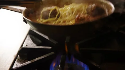 Slow motion spaghetti and meatballs in sautee pan, restaurant kitchen Stock Footage 229808955