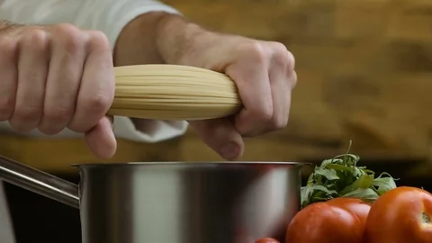Slow-motion. spaghetti shooting breaks over the table with vegetables Stock Footage 77844894
