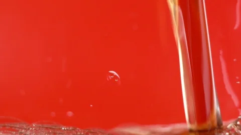 Slow Motion sparkling bubbles on a red background. Cola Is Filled In A Glass Stock Footage 122994069