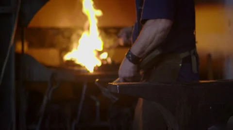 Slow motion sparks as blacksmith beats hot metal on anvil HD Stock Footage