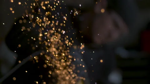 Slow motion sparks shoot up from a chainsaw hitting metal. Stock Footage 64090985