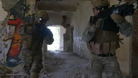 Slow motion of special forces army squad running and spreading through ruins  Stock Footage 78032899