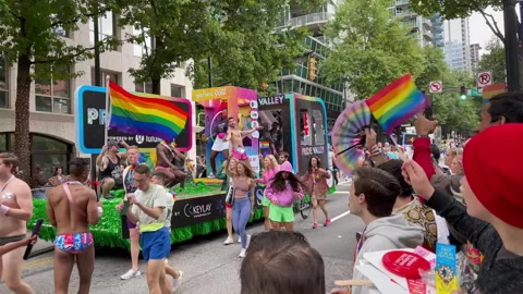 Slow motion spectators watch float at annual Atlanta pride parade Stock Footage 274367463