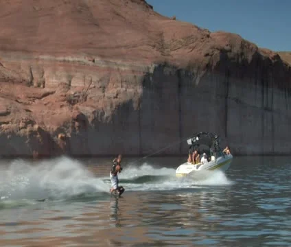 Slow-motion speedboat pulls wake boarder Lake Powell Utah  shot Stock Footage 21660391
