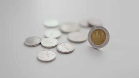 Slow motion spin of a 10 shekel coins next to other Israeli coins Stock Footage 109482013