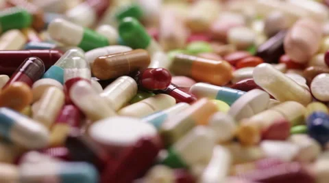 Slow motion of spinning pills Stock Footage