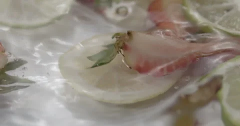 Slow Motion Splash: Lemons and Strawberries Falling into Water - Vibrant Fruit Stock Footage 273531760