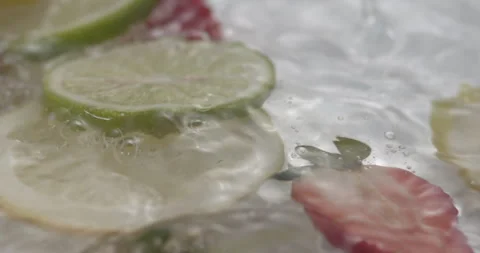Slow Motion Splash: Lemons and Strawberries Falling into Water - Vibrant Fruit Stock Footage 273531792