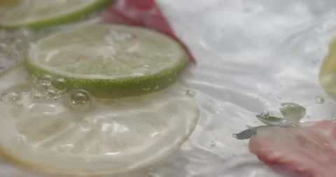 Slow Motion Splash: Lemons and Strawberries Falling into Water - Vibrant Fruit Stock Footage 273532136