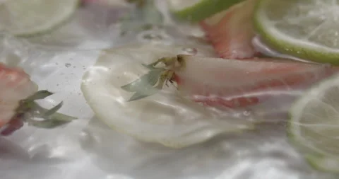 Slow Motion Splash: Lemons and Strawberries Falling into Water - Vibrant Fruit Stock Footage 273532138