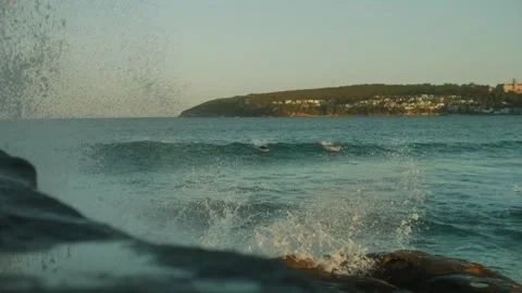 Slow motion splash with out of focus surfers in background in Sydney 4K Stock Footage 246022353