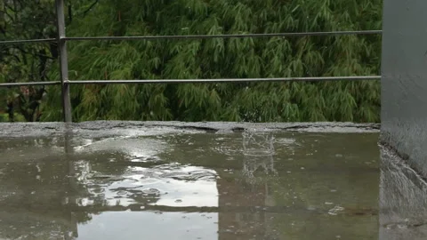 Slow-motion splash of raindrops on wet pavement Видео 313763772