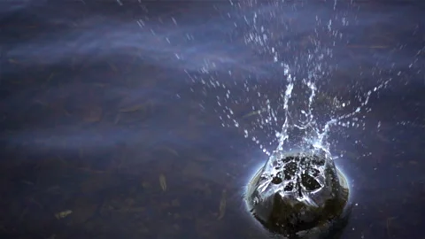 Slow motion splash of water splash from falling stone into water. Stock Footage 117337707