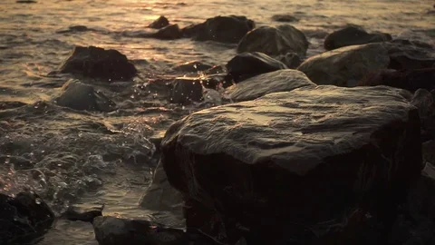 Slow motion splash of a wave on a rock on the shore Stock Footage 80530962