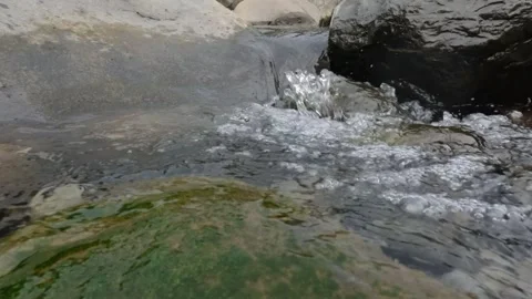 Slow motion splashing water flow in rocky creek Stock Footage 306766576