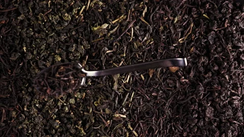 Slow motion spoon dropped onto tea leaves 스톡 동영상 135296281