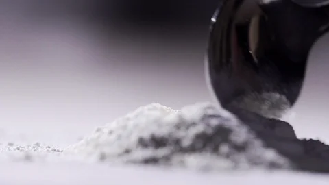 Slow motion spoon pushing white powder Stock Footage 85578766