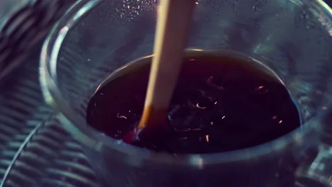 Slow motion, spoon stir mixing hot black coffee drink in glass cup Stock Footage 146052505