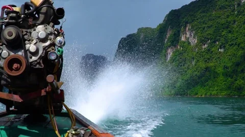 Slow motion of spray flying from the motor engine of the longtail boat. Video stock 82679426
