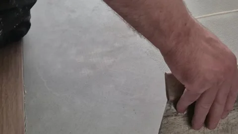 Slow Motion Spreading Adhesive Glue on Floor Stock-Footage 336430431