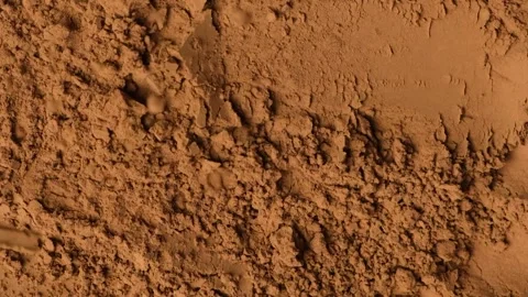 Slow motion sprinkle of aromatic cacao powder creating dusty texture Stock Footage 335836126