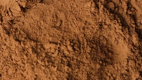 Slow motion sprinkle of aromatic cacao powder creating dusty texture Stock Footage 340166746