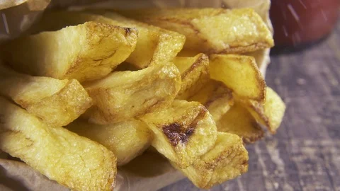 Slow motion sprinkle salt on fried potatoes close up Video stock 96210737
