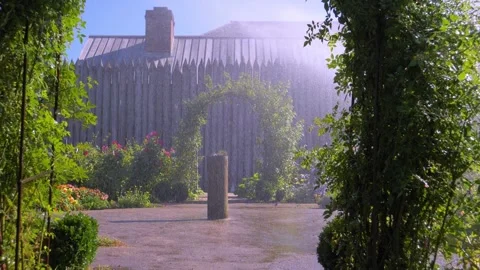Slow Motion Sprinkler Mist Through a Garden Archway. Stock Footage 140480183