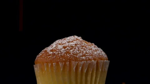 Slow motion Sprinkles falling on cup cake with black background Видео 135641732
