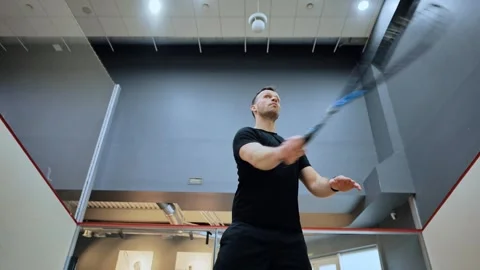 Slow motion squash rally with athletic man on indoor court - Training atmosphere Stock Footage 307195144