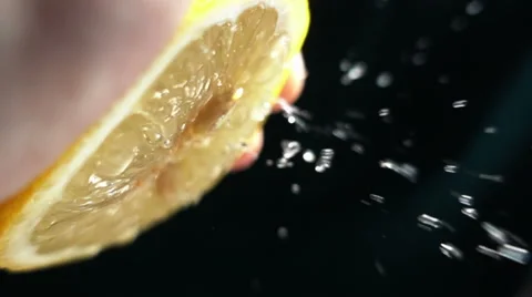 Slow Motion squeeze juice from lemon close up Stock Footage 68686165