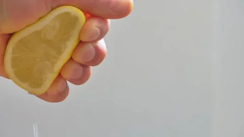 Slow Motion squeeze juice from lemon close up Video stock 257212954
