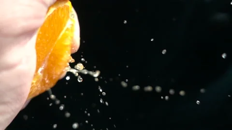 Slow Motion squeeze juice from mandarin close up Stock Footage 68686173
