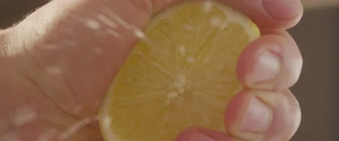 Slow motion squeezing lemon juice 4K Stock Footage 56605123