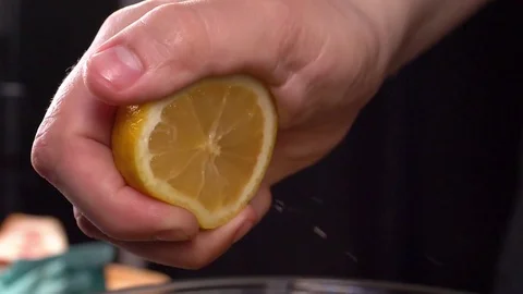 Slow motion squeezing lemon juice slow motion Stock Footage 84603784