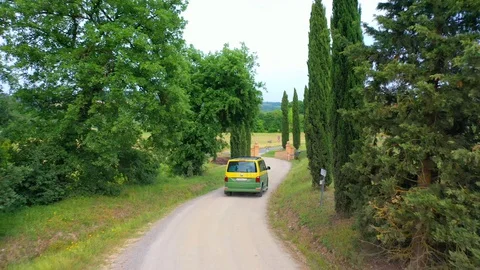 Slow motion stabilized shot - Famous cypress trees row along Tuscany road by POV Stock Footage 128757245