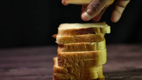 Slow Motion Stacking of Soft Wheat Bread Slices in Moody Studio Lighting. Stock Footage 331030697