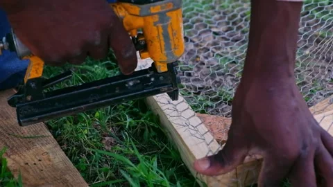 Slow Motion Stapling Wire Mesh to Wooden Frame Stock Footage 320840981