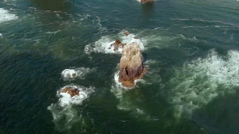 Slow motion static aerial shot flying over rocks off the coast of Oregon. Stock Footage 312821147